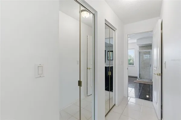 a spacious bathroom with a mirror a sink and a shower