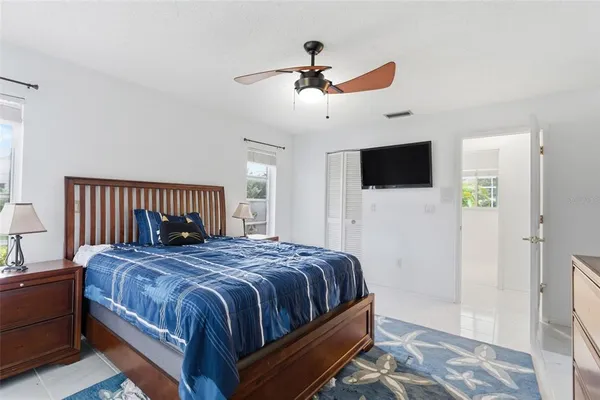 an empty room with a ceiling fan and shower