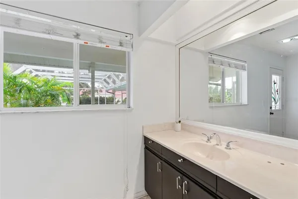 a bathroom with a sink toilet and a mirror