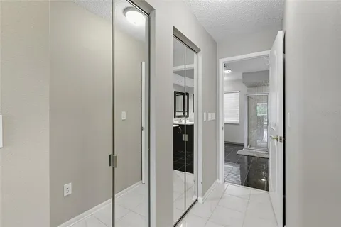 a spacious bedroom with a bed and a chandelier