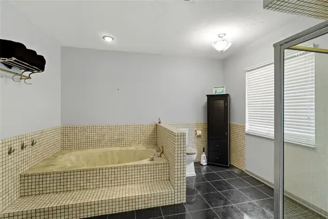 a room with pool table and windows