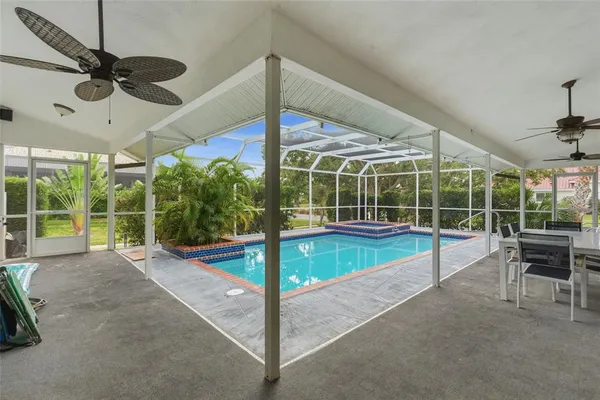 a view of a patio with a table and chairs under an umbrella
