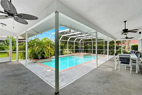 a view of a swimming pool with seating area