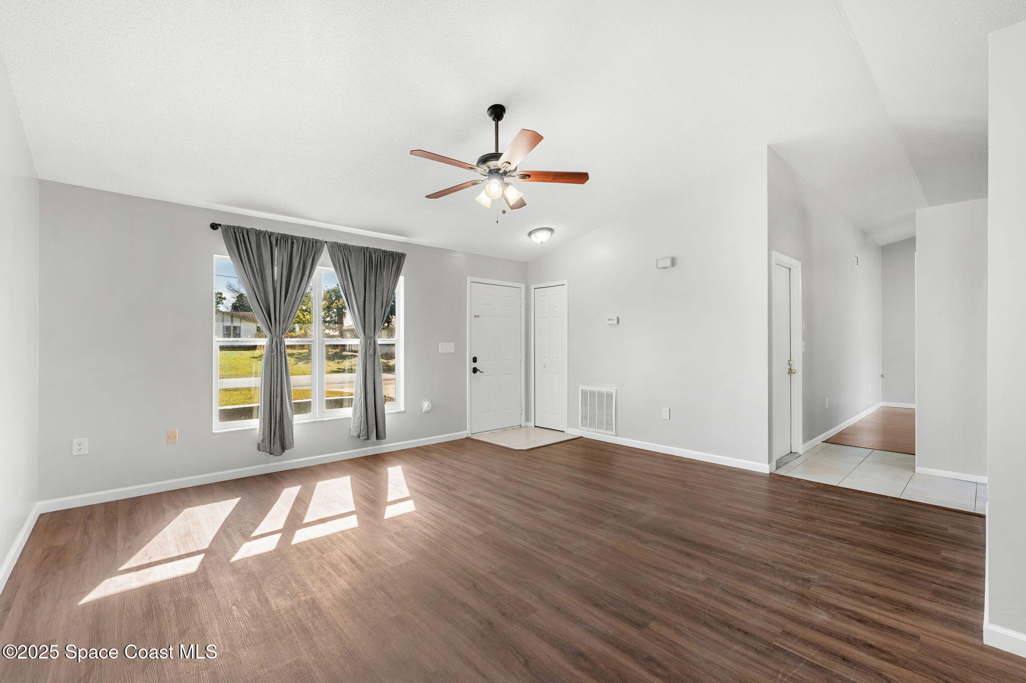 4852 Alfred Street Cocoa, FL 32927 - Photo 12 of 59 an empty room with wooden floor and windows