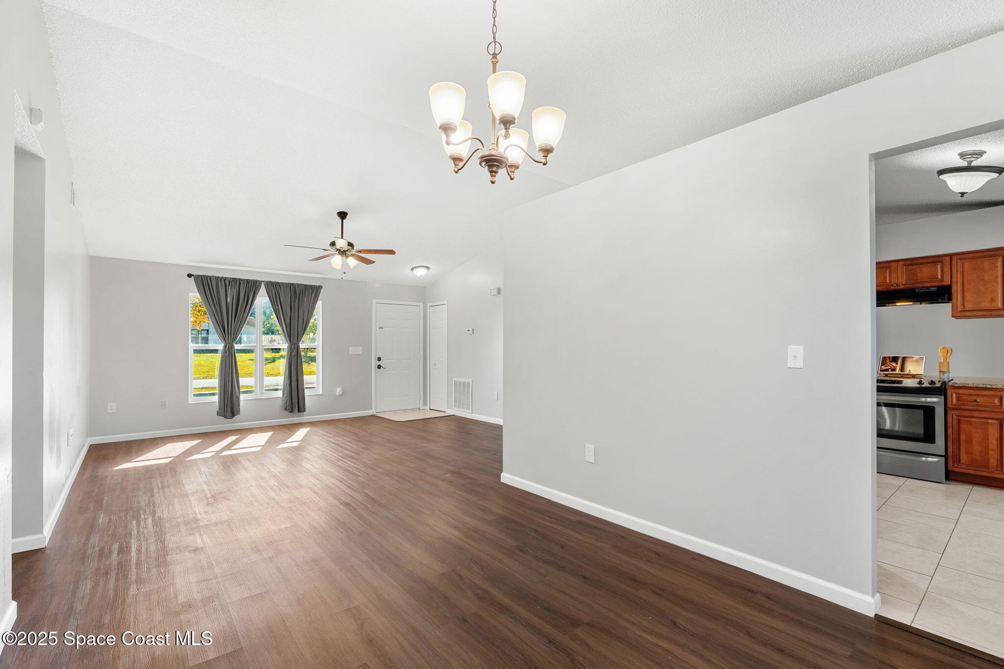 4852 Alfred Street Cocoa, FL 32927 - Photo 16 of 59 a view of an empty room with window and wooden floor