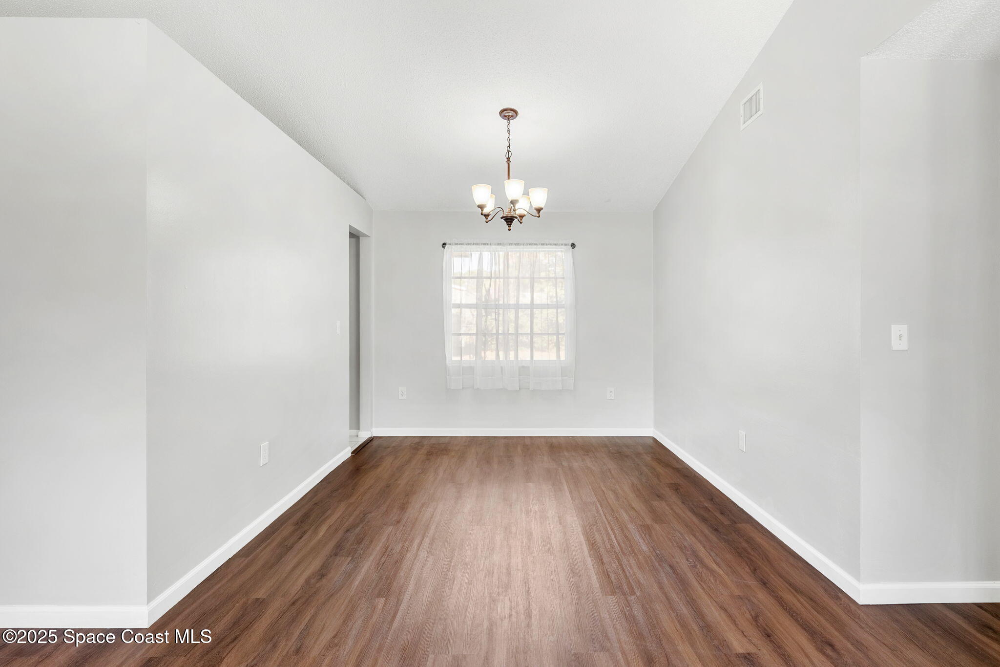 4852 Alfred Street Cocoa, FL 32927 - Photo 19 of 59 wooden floor in an empty room with a window