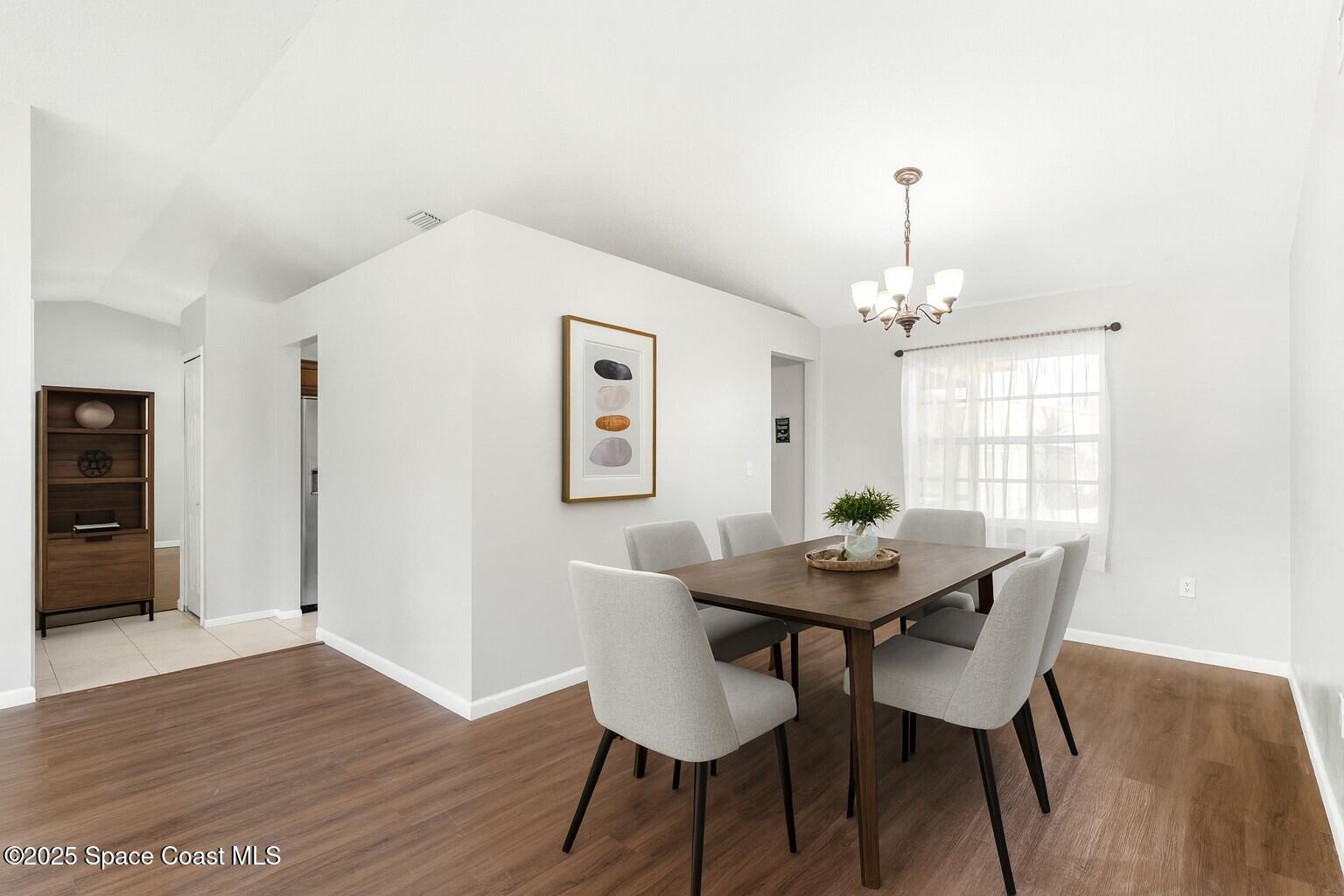 4852 Alfred Street Cocoa, FL 32927 - Photo 22 of 59 a view of a dining room with furniture and wooden floor