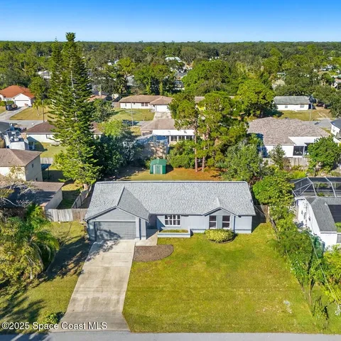 an aerial view of a house with a garden