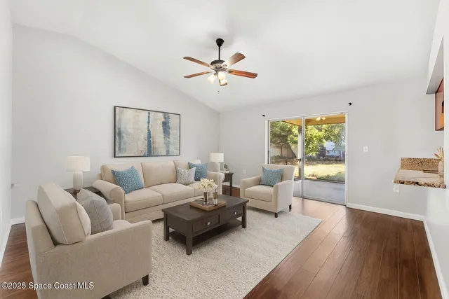 an empty room with a window and a ceiling fan