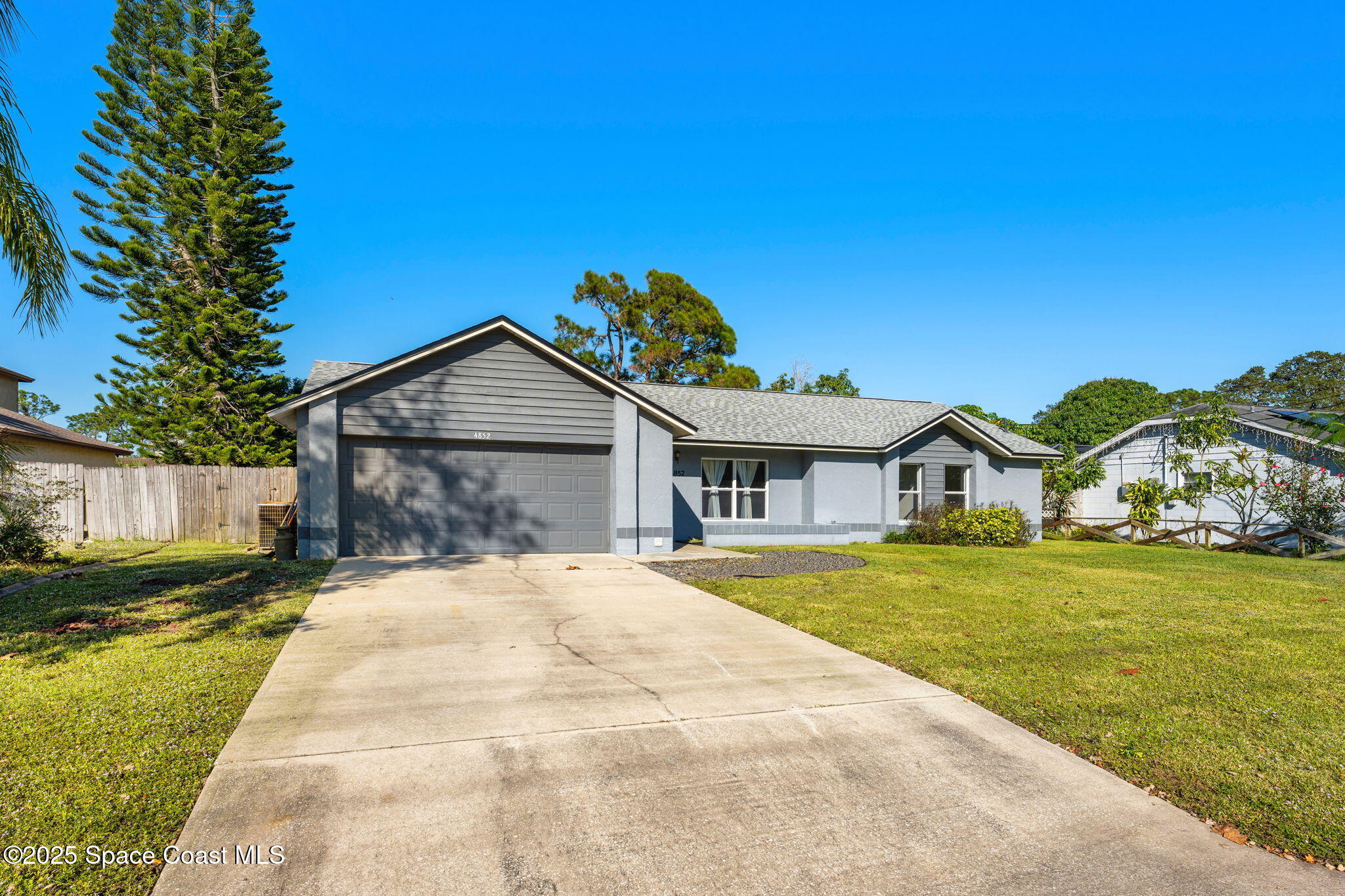 4852 Alfred Street Cocoa, FL 32927 - Photo 57 of 59 a front view of a house with a yard