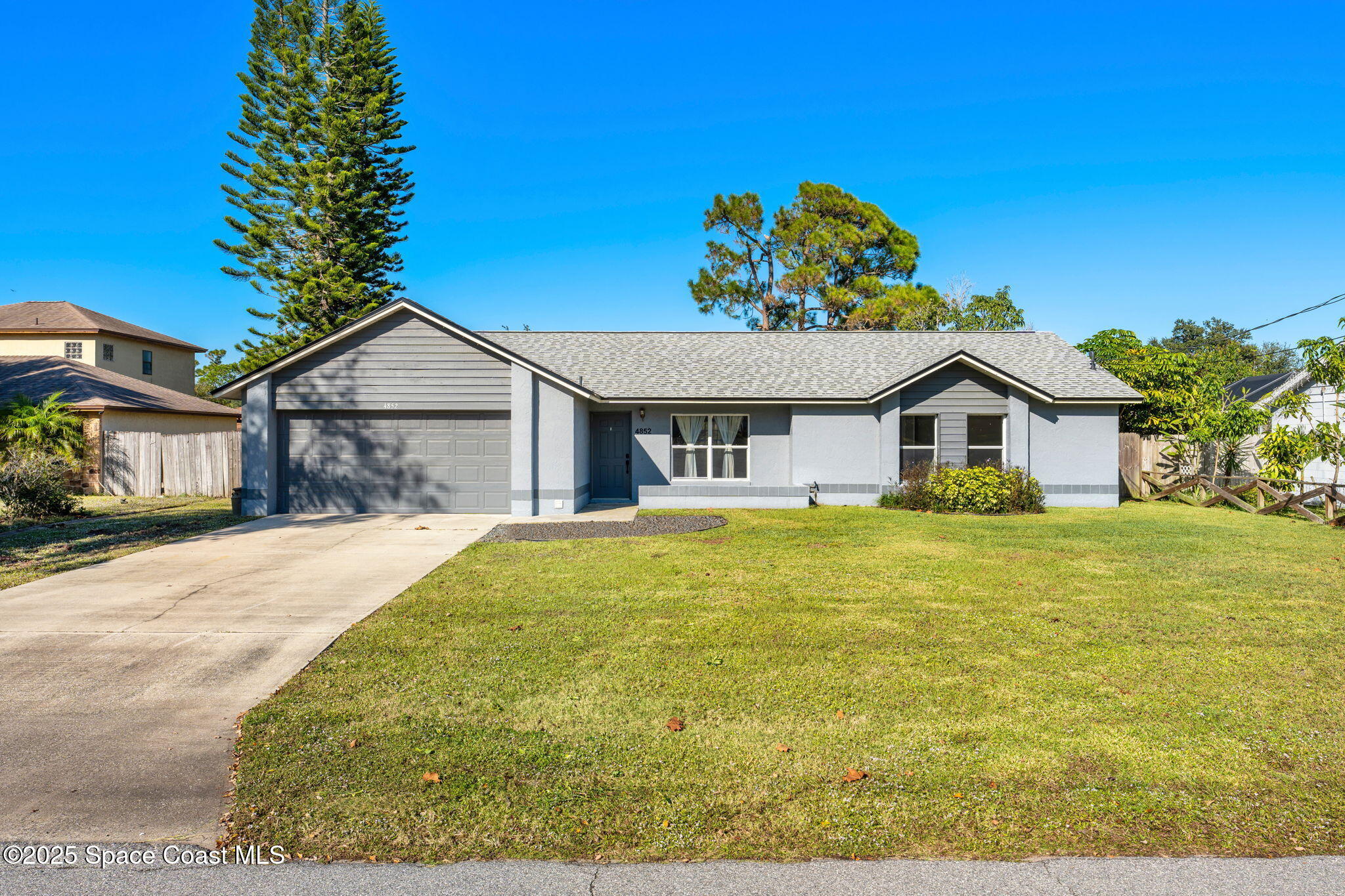 4852 Alfred Street Cocoa, FL 32927 - Photo 10 of 59 a front view of a house with a garden