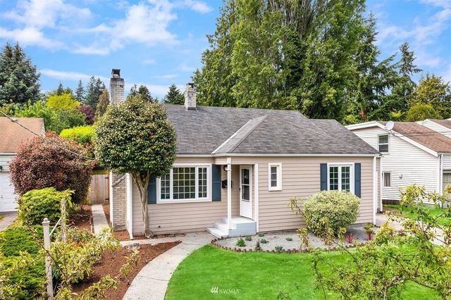 a house with green field in front of it