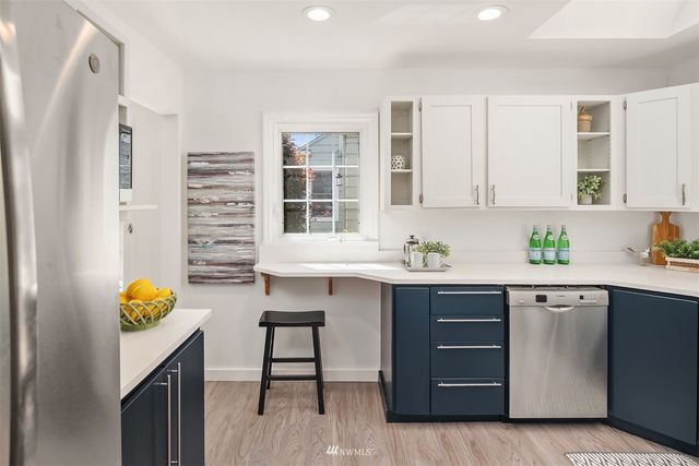 a kitchen with a sink cabinets and window