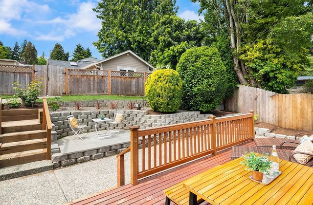 a view of a chairs and tables in the back yard