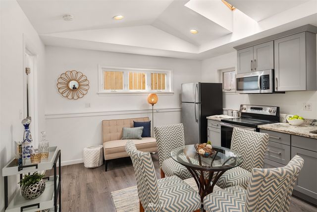a kitchen with a refrigerator and a stove top oven