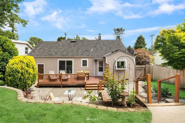 a front view of a house with a yard table and chairs
