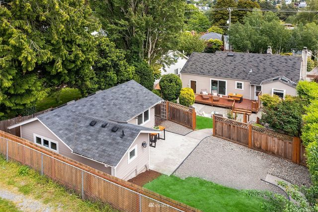 an aerial view of a house having patio with a garden