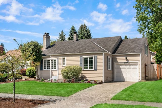 a front view of a house with a garden