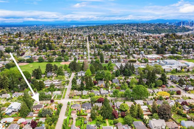 an aerial view of residential houses with city view