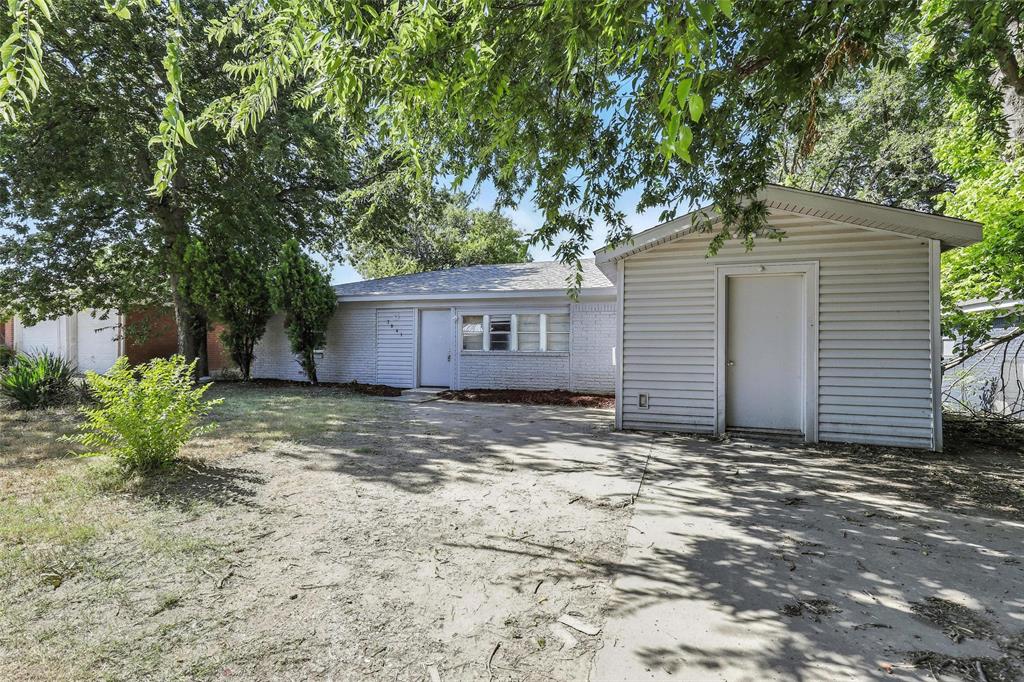 a view of a house with a tree in the yard