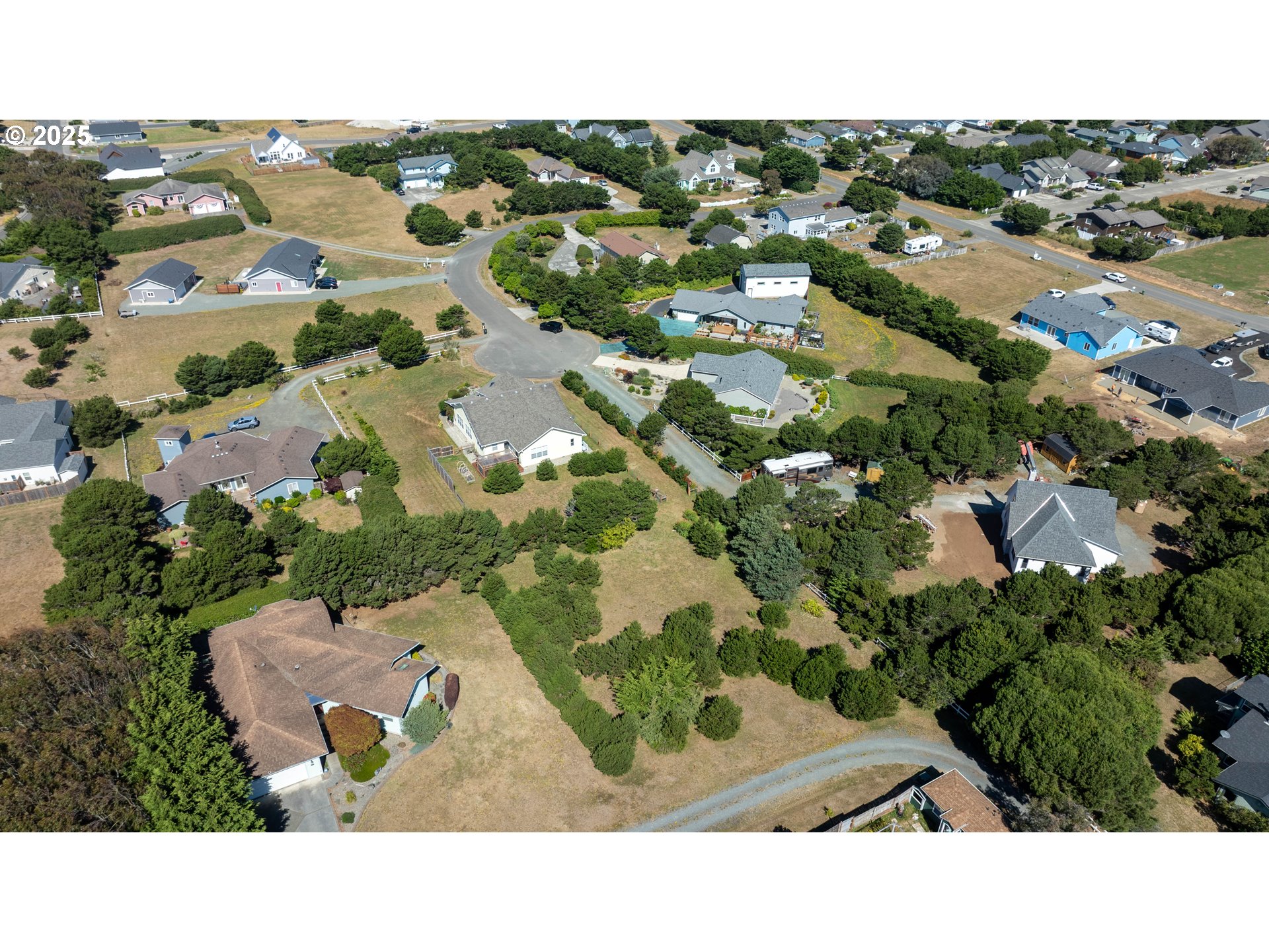 Grant Place, Unit 700 Bandon, OR 97411 - Photo 10 of 17 an aerial view of a house with a yard
