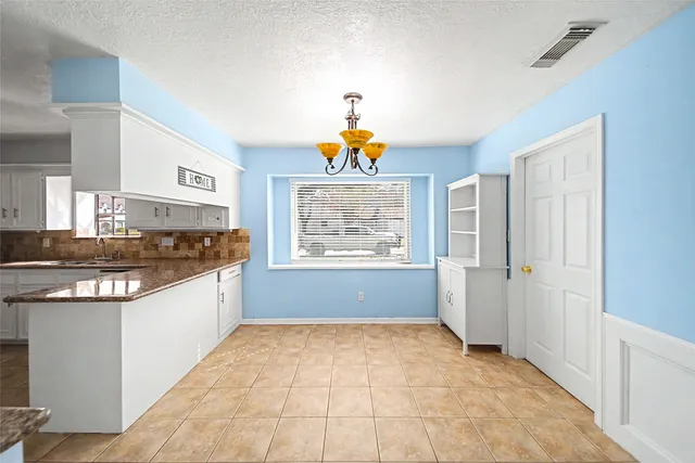 a kitchen with stainless steel appliances a stove a sink and a refrigerator