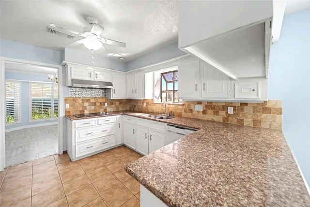 a large kitchen with kitchen island a sink stainless steel appliances and cabinets
