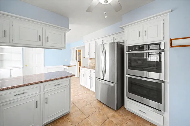 a kitchen with granite countertop cabinets and stainless steel appliances