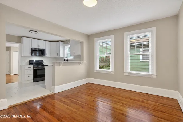 a kitchen with stainless steel appliances granite countertop a refrigerator a stove top oven and a sink