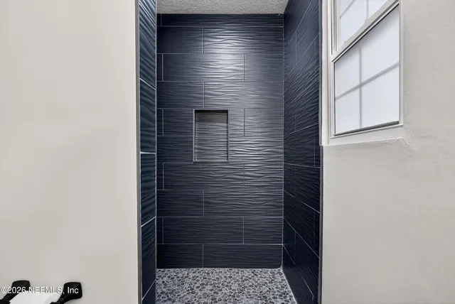 a bedroom with a bed and a potted plant