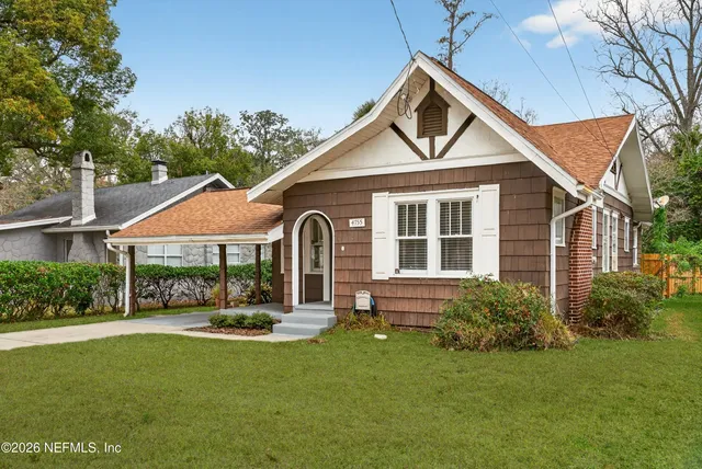 a front view of a house with a yard and porch