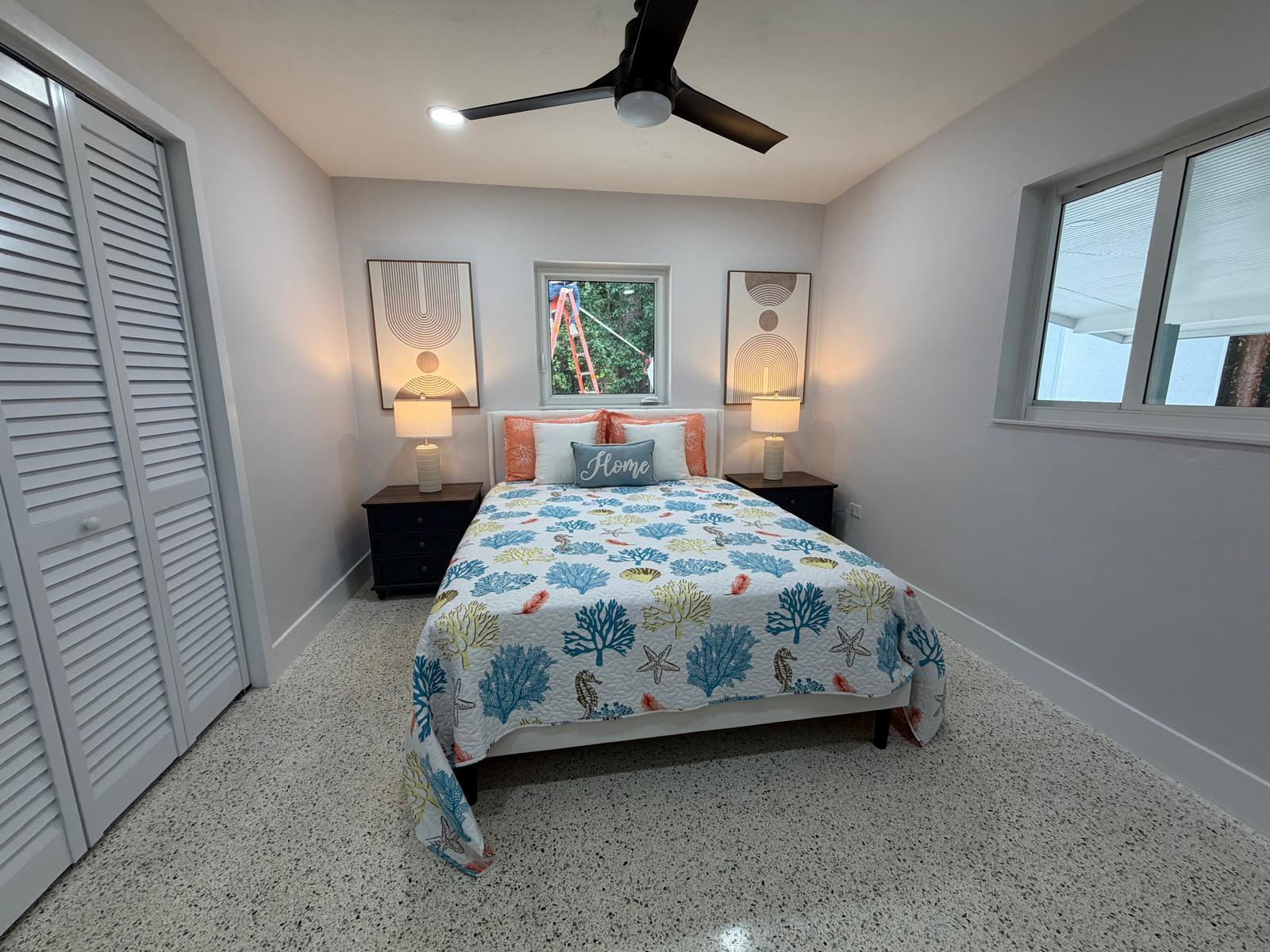 219 South Bay Harbor Drive, Unit A Key Largo, FL 33037 - Photo 11 of 18 a bedroom with a bed a dresser and next to a window
