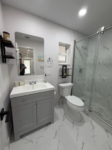 a bathroom with a toilet sink and shower