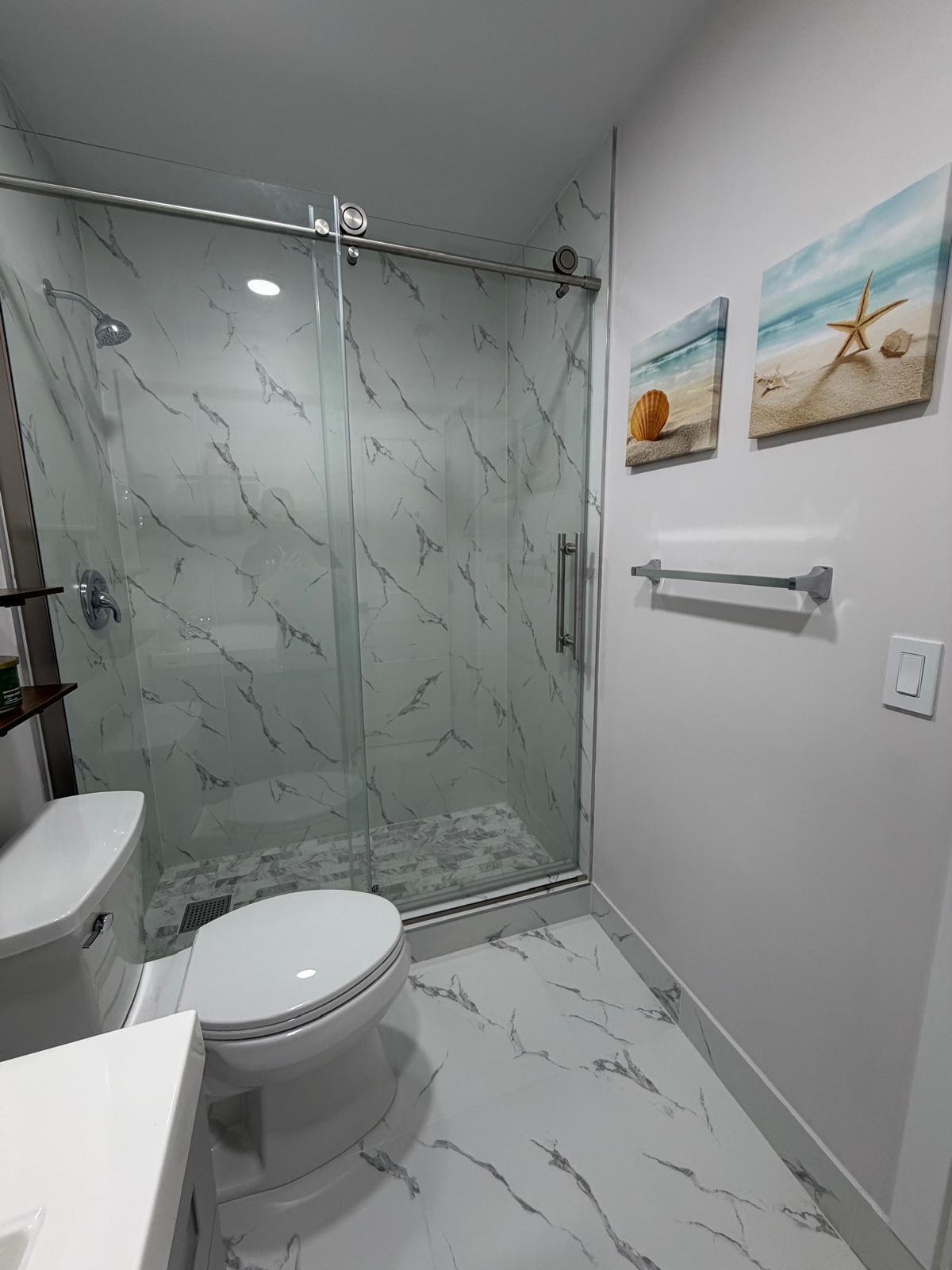 219 South Bay Harbor Drive, Unit A Key Largo, FL 33037 - Photo 14 of 18 a bathroom with a toilet and a shower
