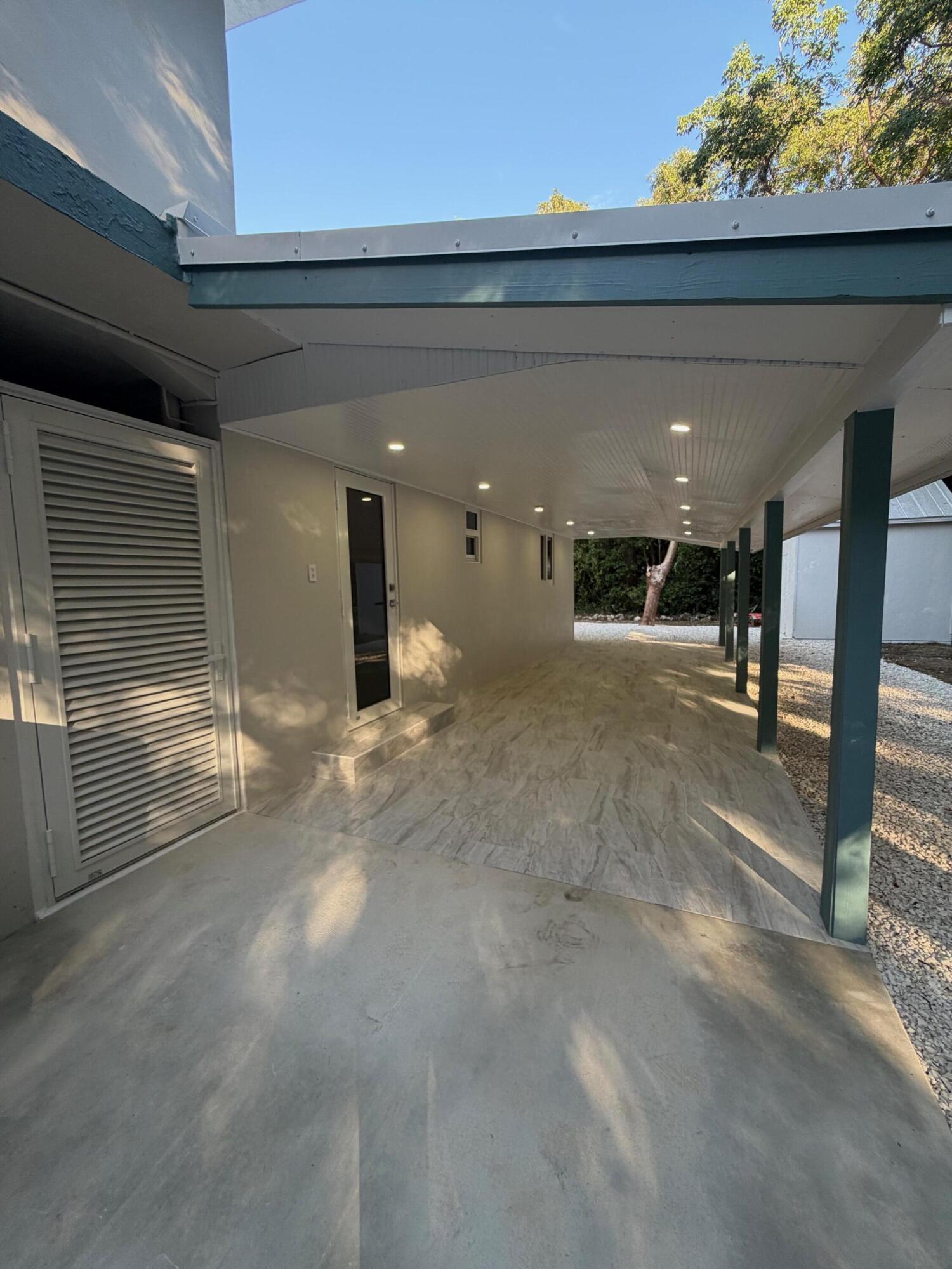 219 South Bay Harbor Drive, Unit A Key Largo, FL 33037 - Photo 16 of 18 a view of a hall with wooden floor