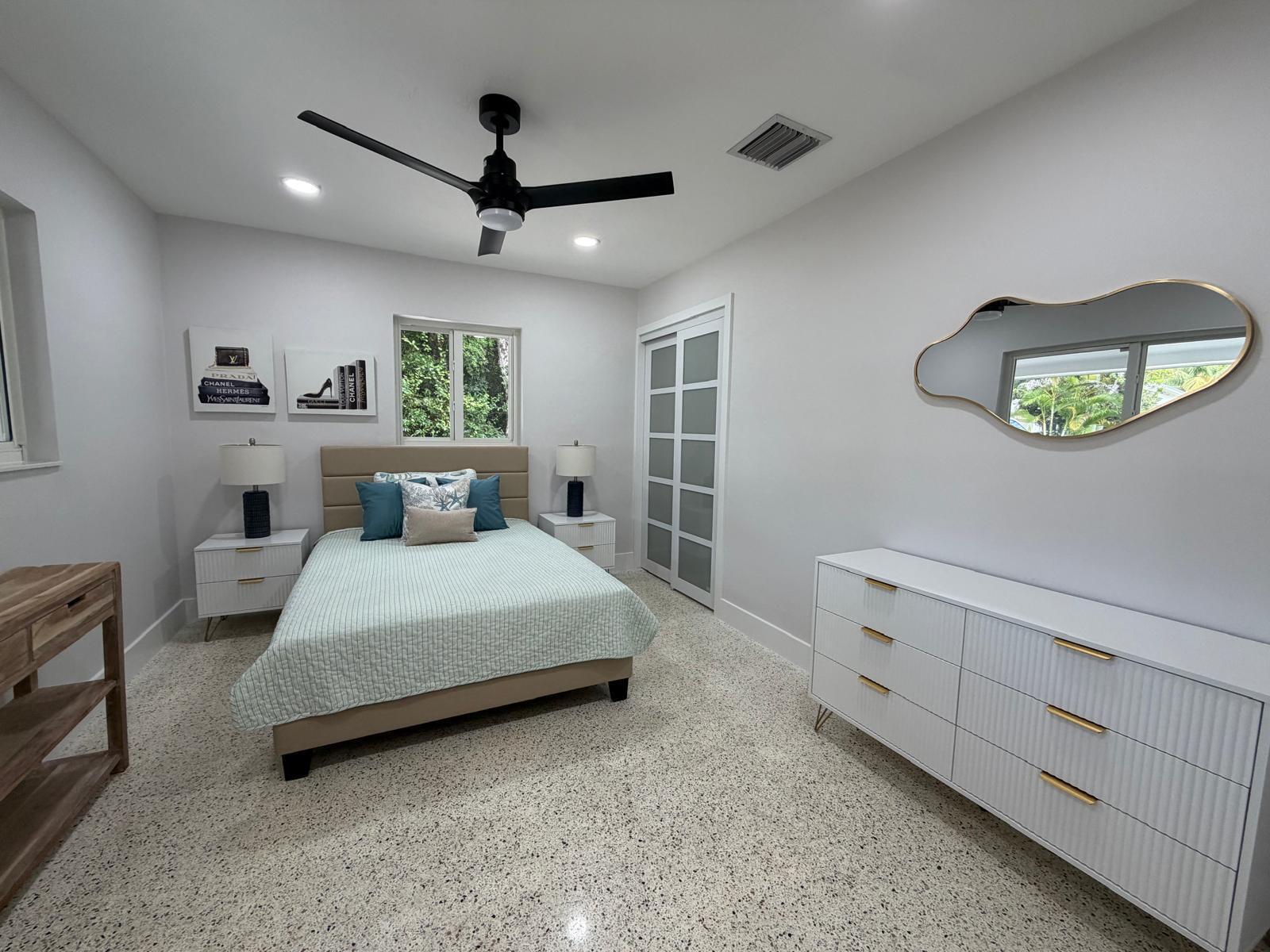 219 South Bay Harbor Drive, Unit A Key Largo, FL 33037 - Photo 9 of 18 a spacious bedroom with a bed and a window