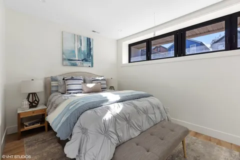 a bedroom with a bed and wall painting