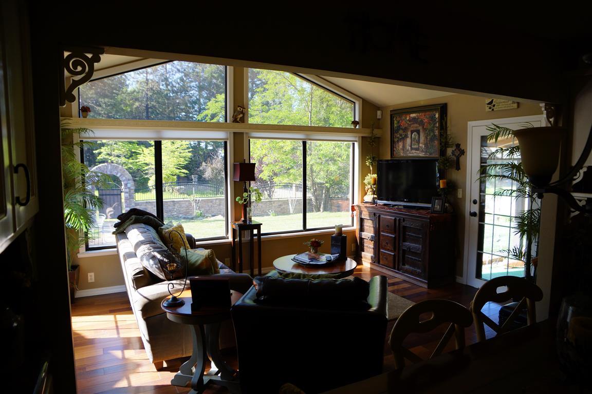 14388 Fern Road Whitmore, CA 96096 - Photo 18 of 52 a living room with furniture and a floor to ceiling window