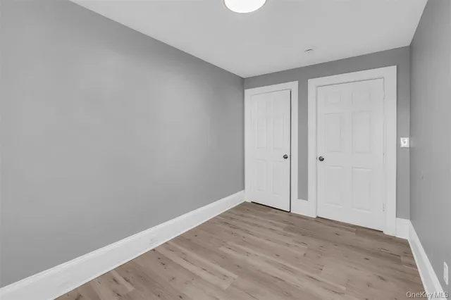 a view of room with wooden floor