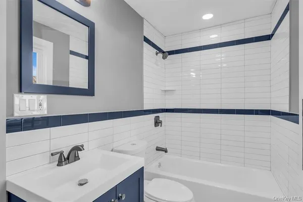 a bathroom with a bathtub shower sink and a toilet