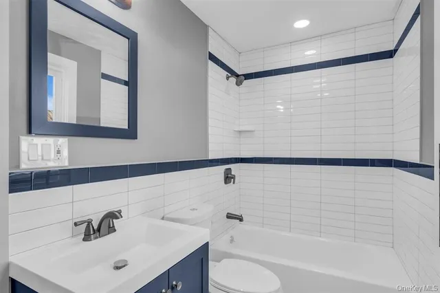 a bathroom with a bathtub shower sink and a toilet