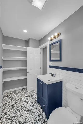a bathroom with a sink toilet vanity and tub