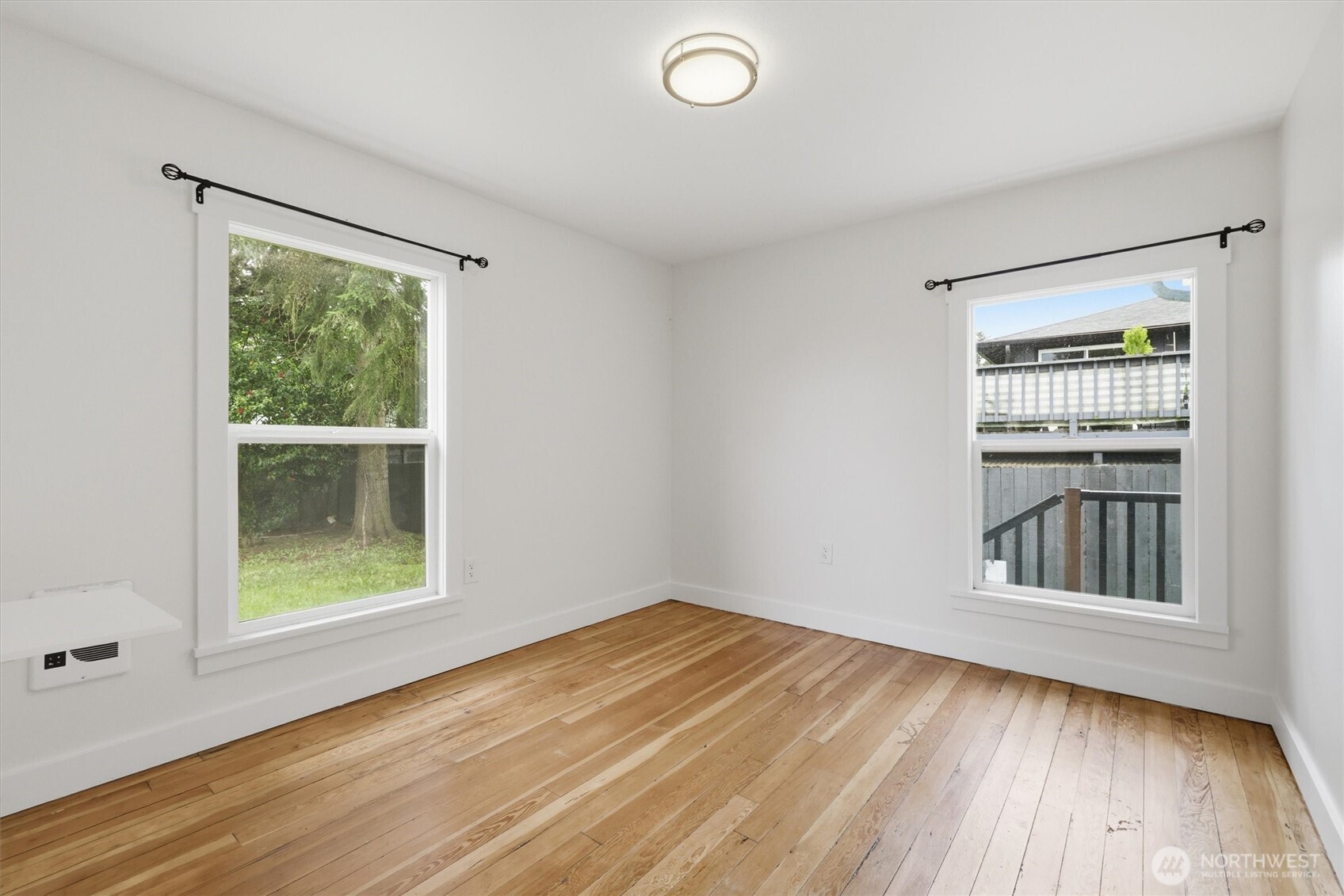 1651 Southwest 114th Street Seattle, WA 98146 - Photo 19 of 37 an empty room with wooden floor and windows