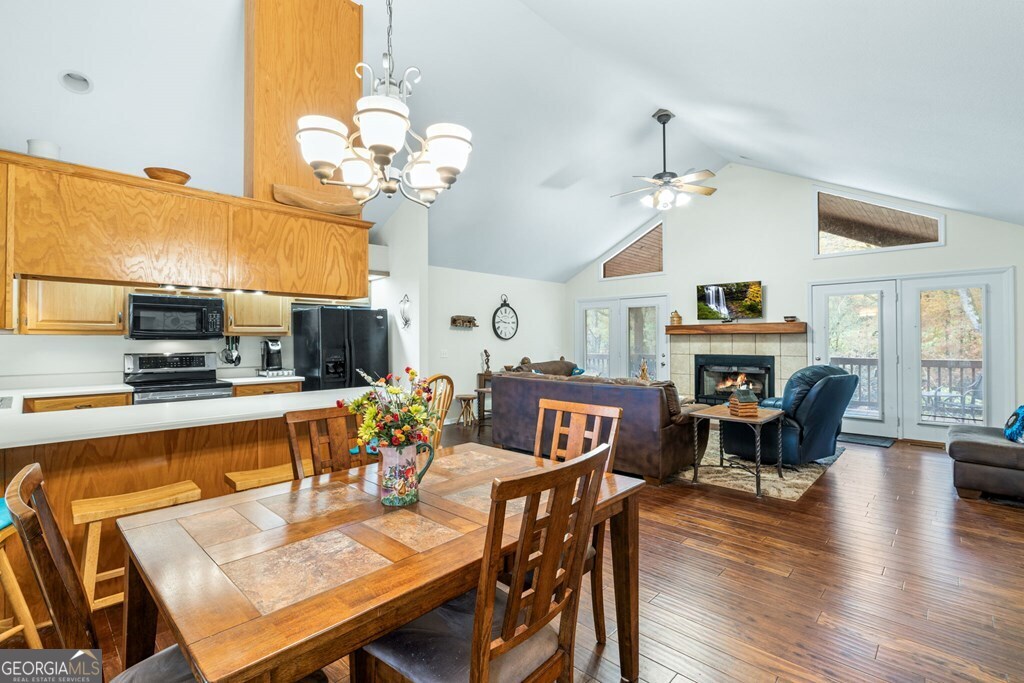 251 Rivers Edge Drive Hayesville, NC 28904 - Photo 11 of 45 a view of a dining room with furniture a chandelier and wooden floor