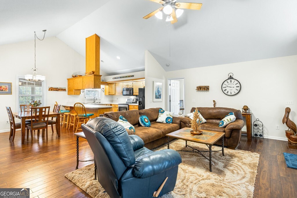 251 Rivers Edge Drive Hayesville, NC 28904 - Photo 12 of 45 a living room with furniture kitchen view and a wooden floor