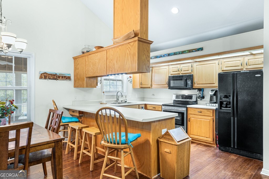 251 Rivers Edge Drive Hayesville, NC 28904 - Photo 14 of 45 a kitchen with stainless steel appliances granite countertop a sink dishwasher a stove a refrigerator with a dining table and chairs