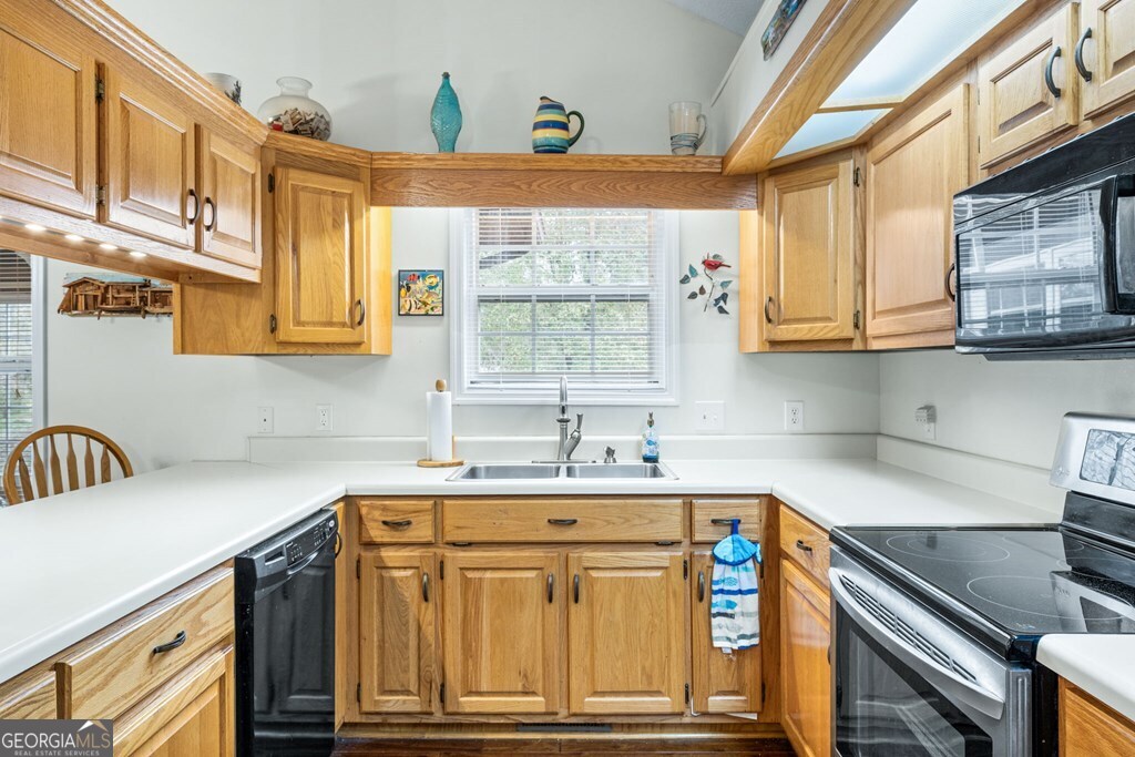 251 Rivers Edge Drive Hayesville, NC 28904 - Photo 16 of 45 a kitchen with stainless steel appliances granite countertop a sink and cabinets