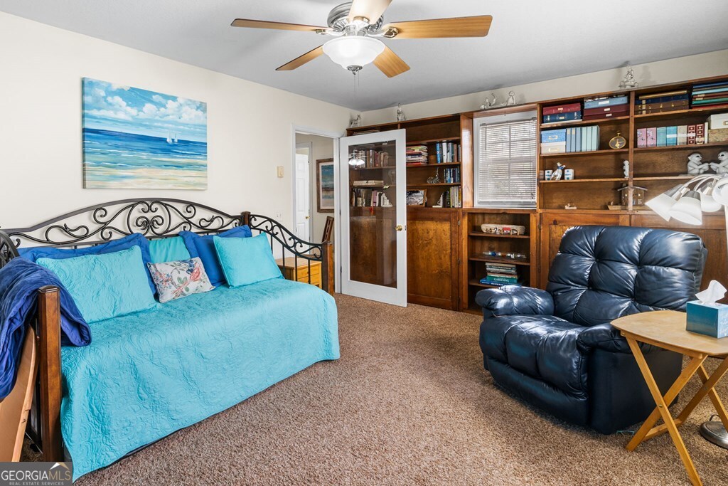 251 Rivers Edge Drive Hayesville, NC 28904 - Photo 19 of 45 a living room with furniture and a book shelf
