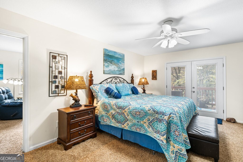 251 Rivers Edge Drive Hayesville, NC 28904 - Photo 22 of 45 a bedroom with a bed and wooden floor