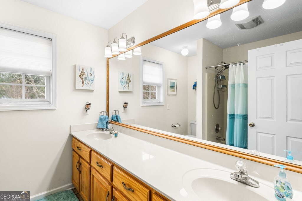 251 Rivers Edge Drive Hayesville, NC 28904 - Photo 24 of 45 a bathroom with a sink double vanity and a mirror